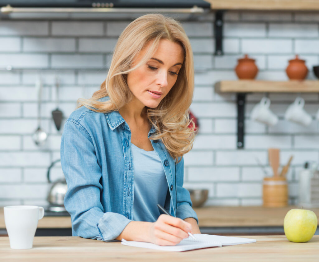 woman working, woman writing, productivity tips, how to be more productive, how to be More Productive In Life
