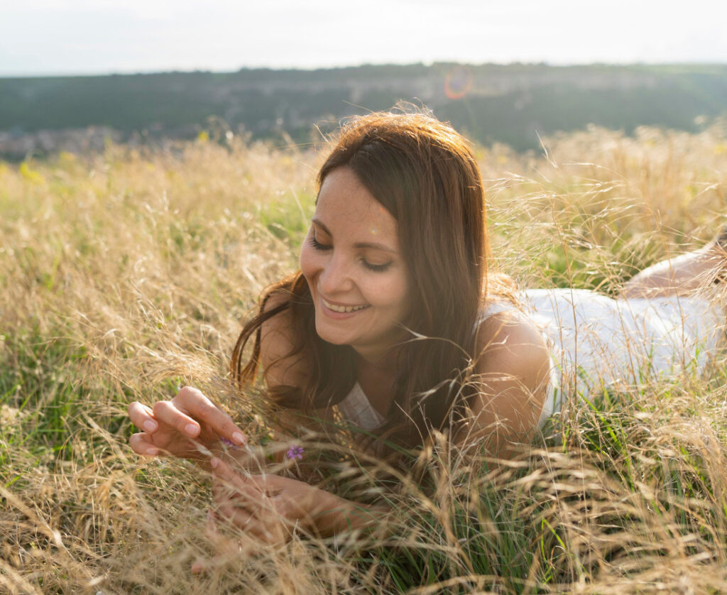woman on a field, woman relaxing, woman in the nature, productivity tips, how to be more productive, how to be More Productive In Life